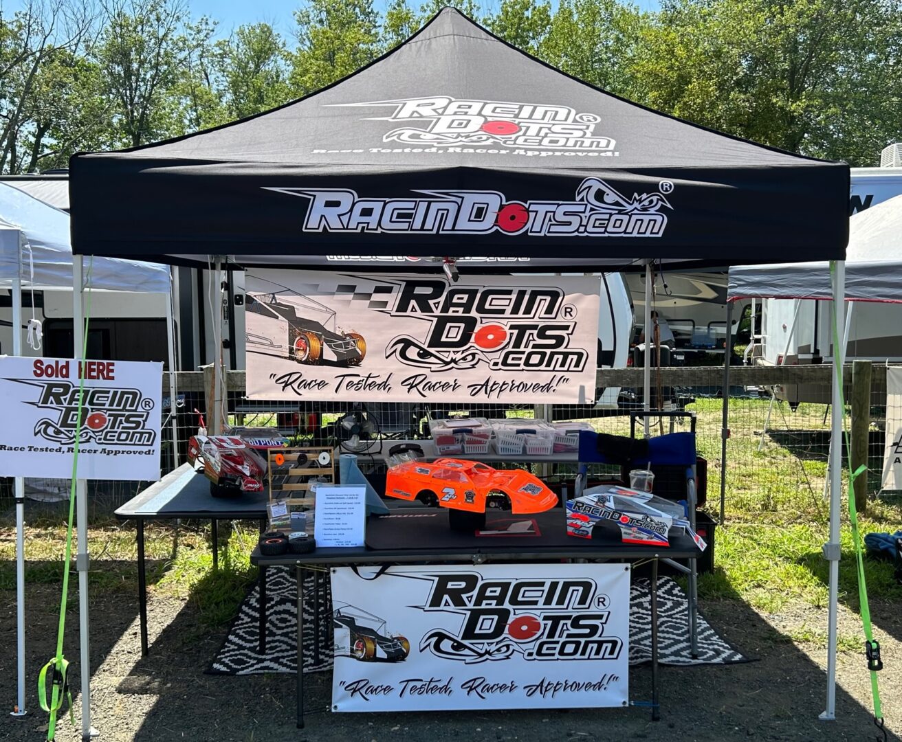 Outdoor booth showcasing Racing Doctor RC car products and accessories.
