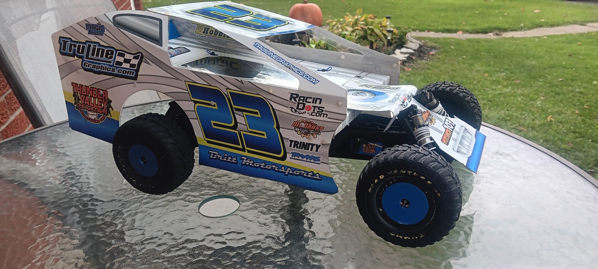 Blue and silver remote-controlled car with number 23 on the side.
