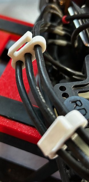 Close-up of bundled black cables with white clips