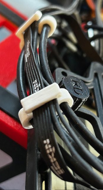 Black cables neatly secured by white clips